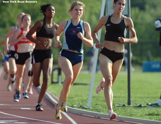 Kate Irvin of the Central Park Track Club (in blue) runs in third place, behind Bohlke.