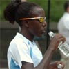 Eventual race winner Lornah Kiplagat hydrates before the race.