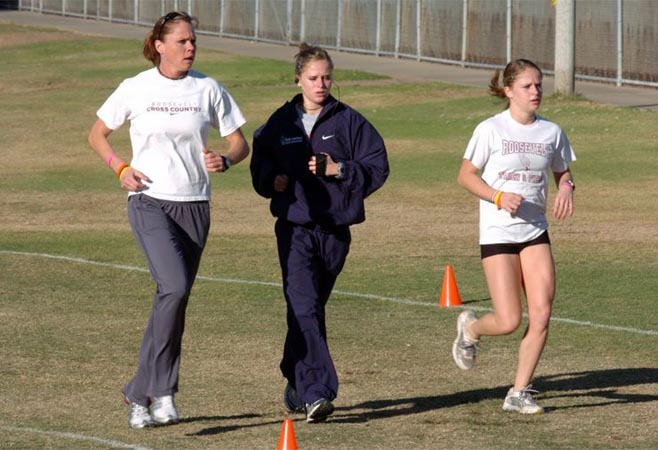 Allison Eckert (left) warms up with her coach and her twin sister, Krista.