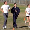 Allison Eckert (left) warms up with her coach and her twin sister, Krista.