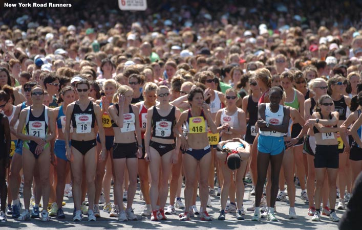 The professional runners stand at the front of a sea of women.