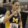 Lindsey Gallo runs hard with one lap to go in the mile final at the 2005 NCAA Indoor T&F Championships.