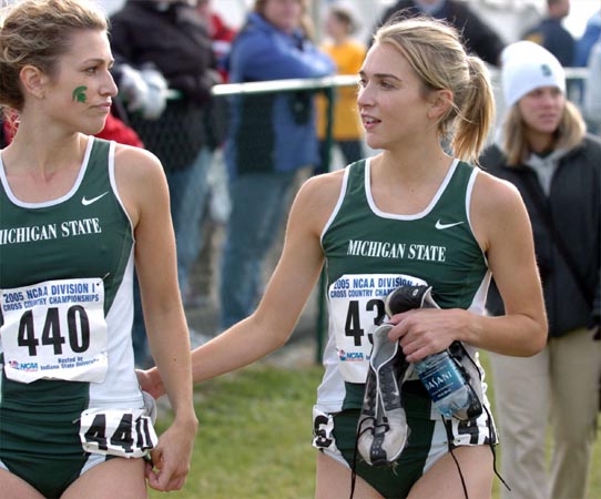 Katie Kelly (right) talks to Michigan State teammate Michelle Rafferty.