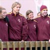 They are coached by Louie Quintana (far right), a former high school national cross country champion and top runner for Villanova.