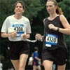 Clarissa Hitchon (right, 204th, 41:25) serves as a guide for Christa Earl (age 47, 205th, 41:25). Both represent the Achilles Track Club.