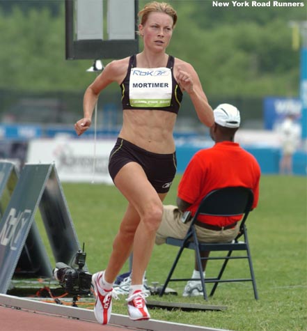 Amy Mortimer, a former Kansas State star who now coaches at Boston College, runs between packs.