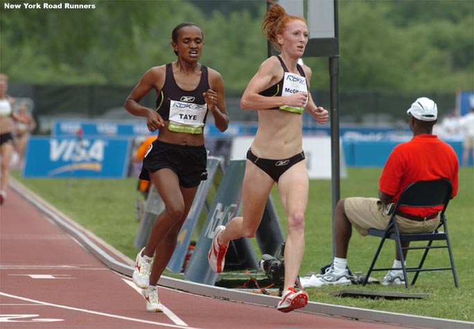 Katie McGregor and Yimenahsu Taye run in eighth and ninth place with two laps to go.