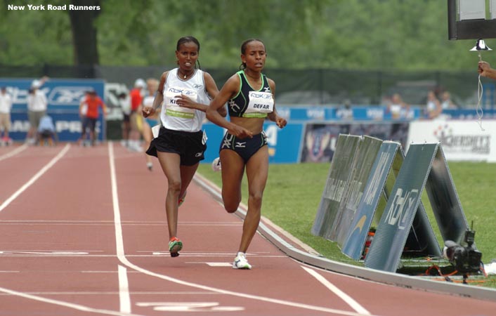 With one lap to go, Meseret Defar had pulled ahead of Werknesh Kidane, but the two were still right together.