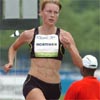 Amy Mortimer, a former Kansas State star who now coaches at Boston College, runs between packs.