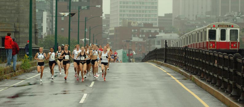 The runners, and the T, head across the bridge.