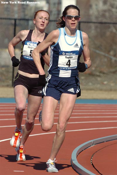 ...under her college coach, Ray Treacy, held off McGregor to take third in 26:02.