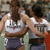 Mary Jayne Harrelson and Treniere Clement head off the track arm in arm.