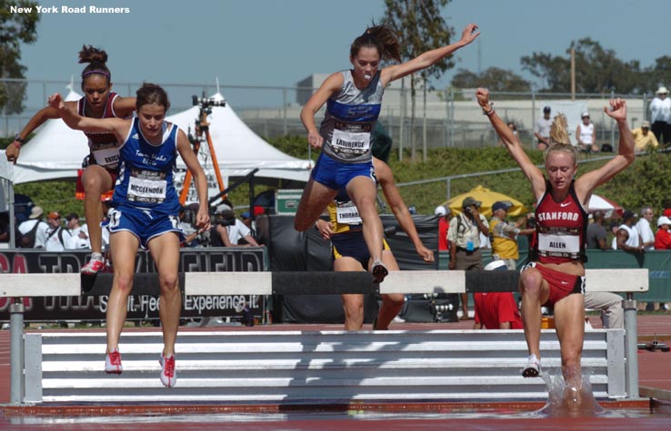 The five runners ran together early in the race. And yes, Marie Lawrence is blowing a bubble with her gum as she goes over the water barrier.