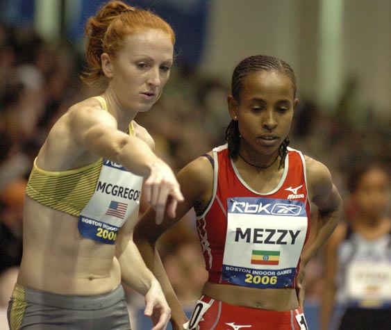 Katie McGregor helps out Meseret Defar before the start.