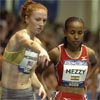 Katie McGregor helps out Meseret Defar before the start.